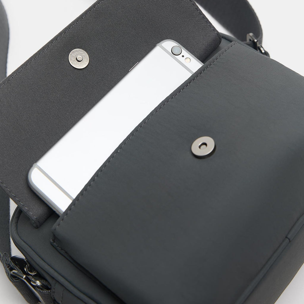 Charcoal Grey Black Compact Flap Bag with Braided Charm Detail and Adjustable Strap